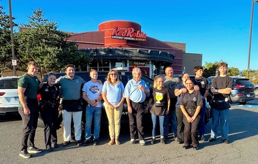 Group of people pose for picture outside of a Red Robin