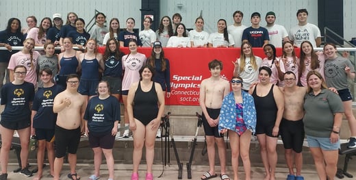 Swim Team members from Team CT pose for picture with UConn students