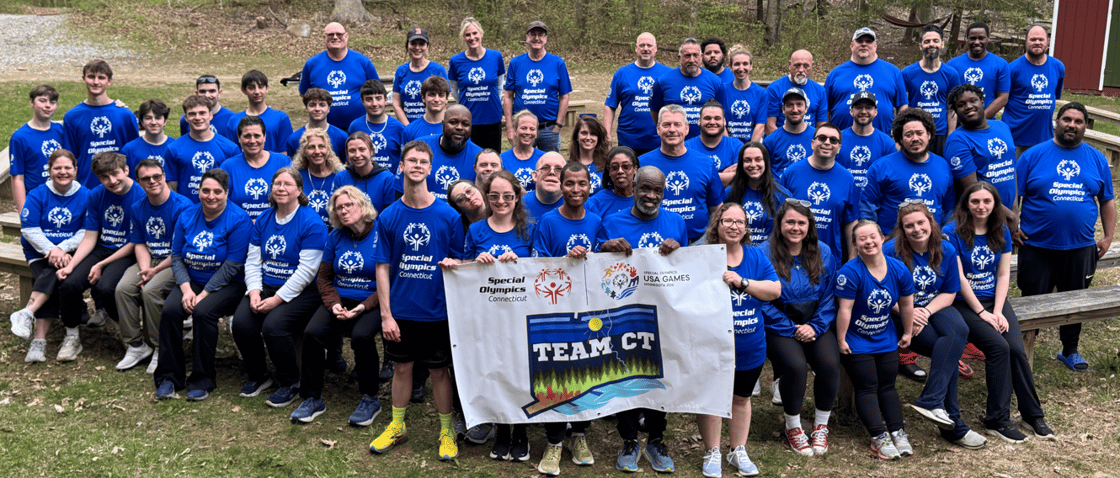 Team CT poses for picture holding Team CT banner